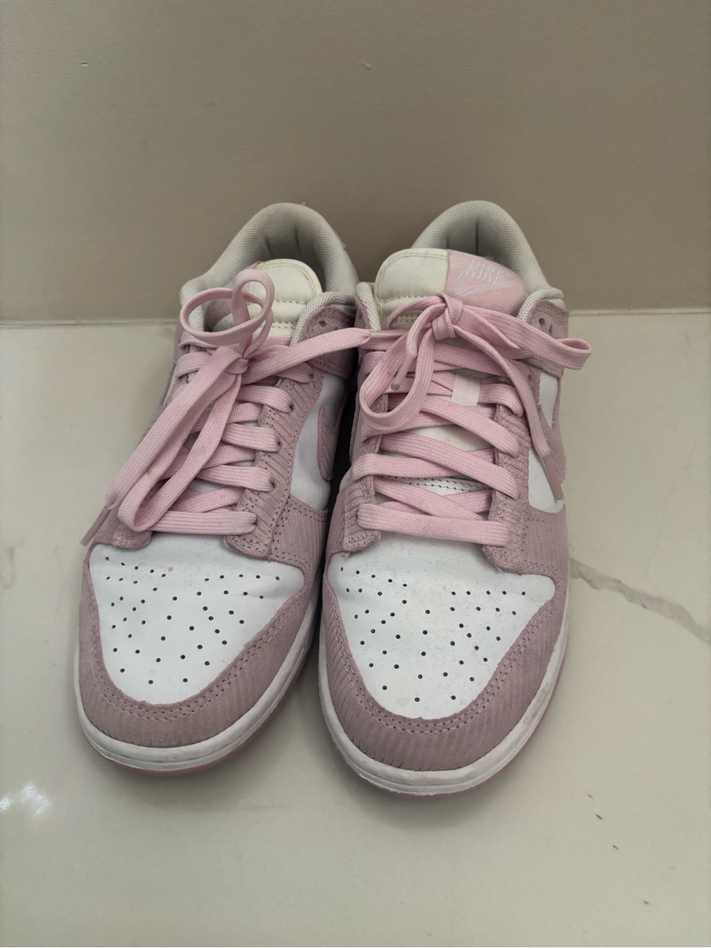 These are Nike Dunk Low Pink Corduroy sneakers in white and pink foam